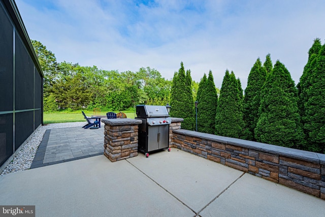 view of patio with grilling area and a fire pit