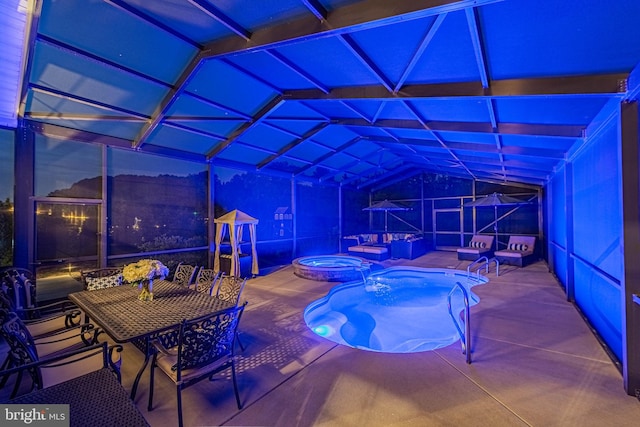view of pool with a patio area and a pool with connected hot tub