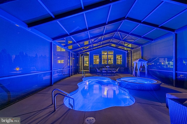 view of swimming pool featuring a patio, a pool with connected hot tub, and a lanai