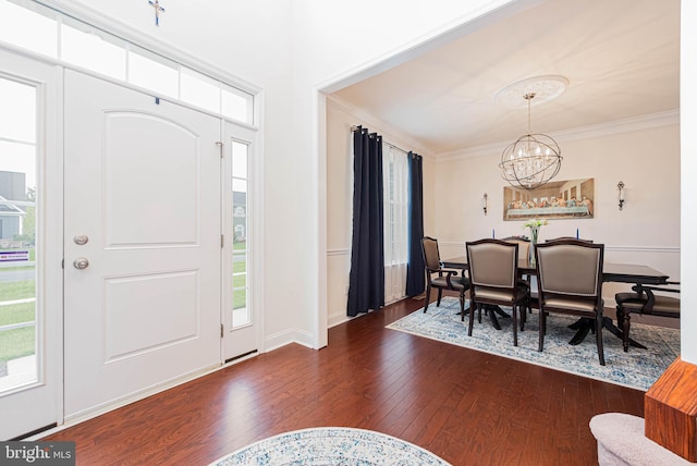 foyer featuring a wealth of natural light, a notable chandelier, and dark wood finished floors