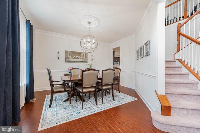 dining space featuring crown molding, dark wood finished floors, stairway, and a notable chandelier