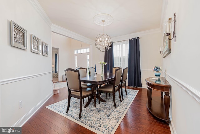 dining area featuring baseboards, dark wood-style flooring, an inviting chandelier, and crown molding