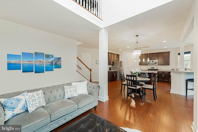 living room featuring stairway, dark wood finished floors, and recessed lighting