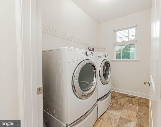 laundry area featuring laundry area, baseboards, independent washer and dryer, and visible vents
