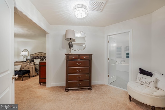 living area featuring baseboards, light carpet, a chandelier, and visible vents
