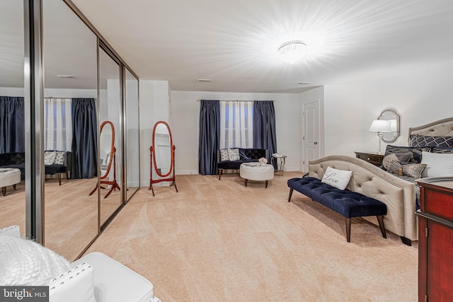 interior space with baseboards and light colored carpet