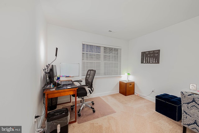 carpeted home office with baseboards