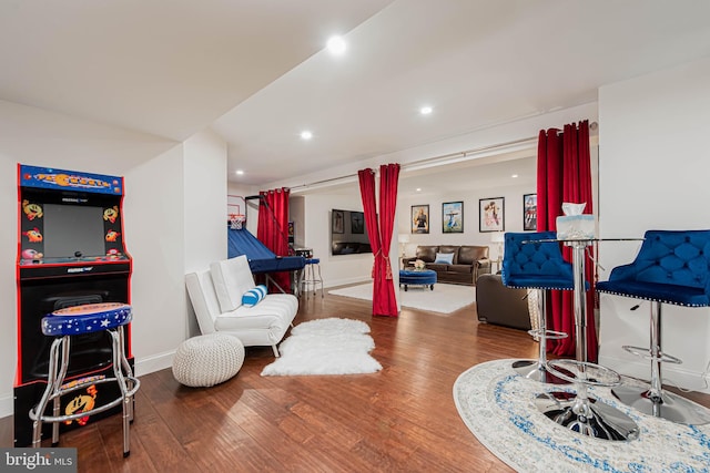 recreation room featuring wood finished floors, baseboards, and recessed lighting
