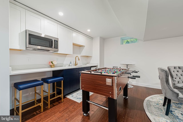 game room featuring a sink, indoor wet bar, recessed lighting, dark wood-style floors, and baseboards