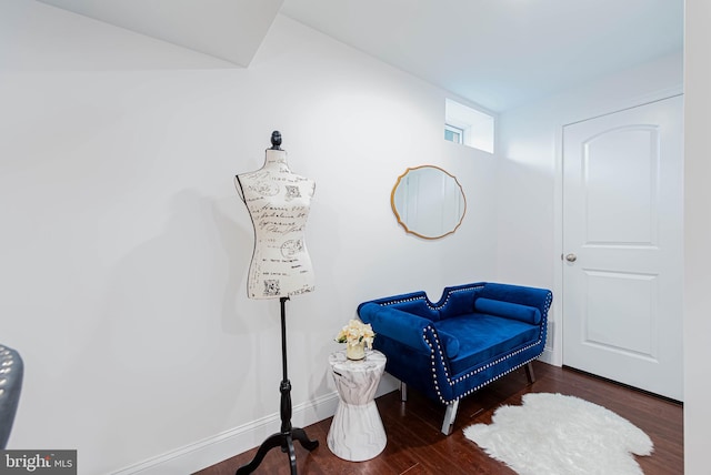 living area featuring baseboards and wood finished floors