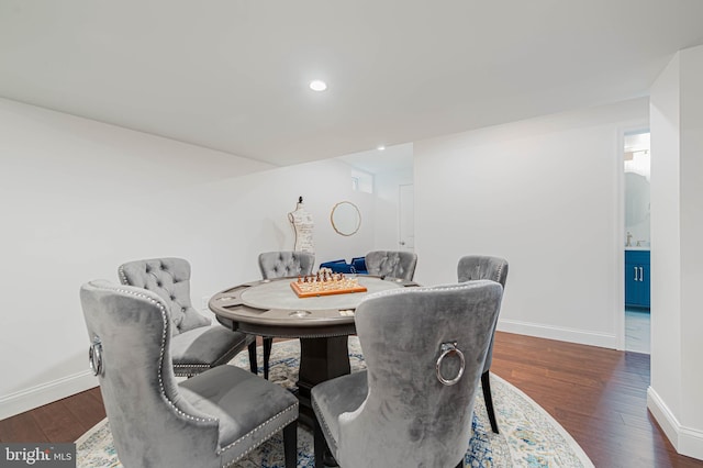 dining space with dark wood-type flooring, baseboards, and recessed lighting