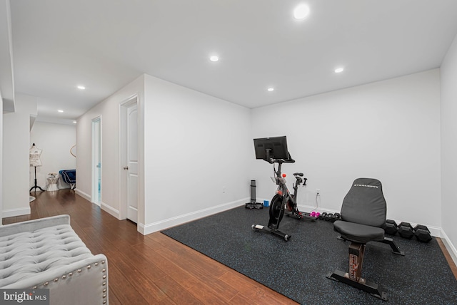 exercise room featuring baseboards, recessed lighting, and wood finished floors