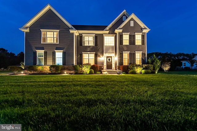 view of front of home with a yard