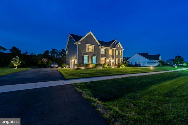 view of front of property with a lawn and driveway