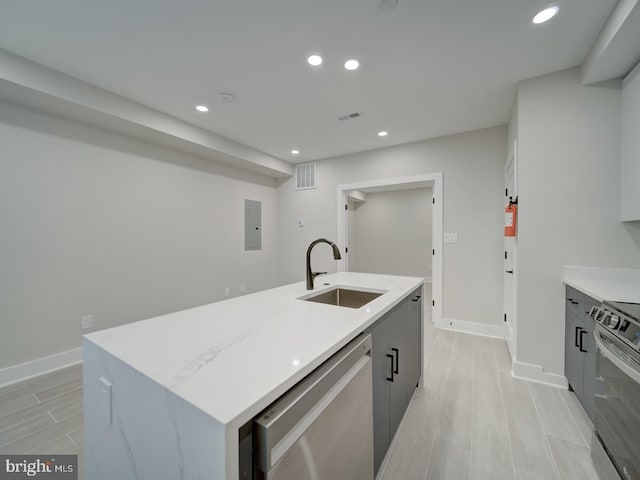 kitchen featuring a sink, appliances with stainless steel finishes, baseboards, and recessed lighting
