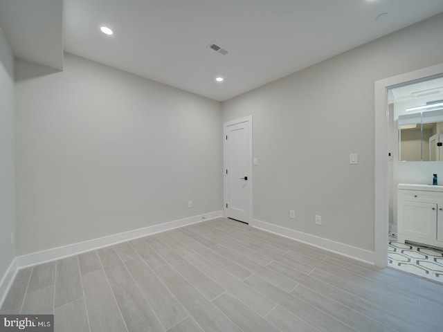spare room with baseboards, recessed lighting, and visible vents