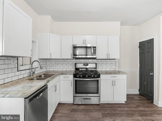 207 Matthes Ave, Wilmington, DE 19804 - kitchen with stainless steel appliances, white cabinets, and a sink