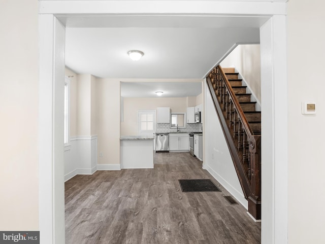 207 Matthes Ave, Wilmington, DE 19804 - unfurnished living room with visible vents, wood finished floors, and stairs