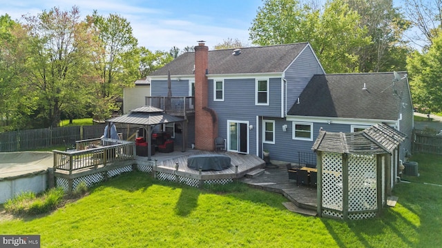 back of house with a wooden deck, cooling unit, a chimney, a gazebo, and fence