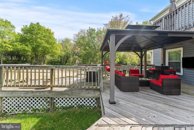 wooden deck featuring an outdoor living space and a gazebo