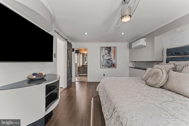 bedroom with dark wood-style floors, recessed lighting, a barn door, crown molding, and baseboards