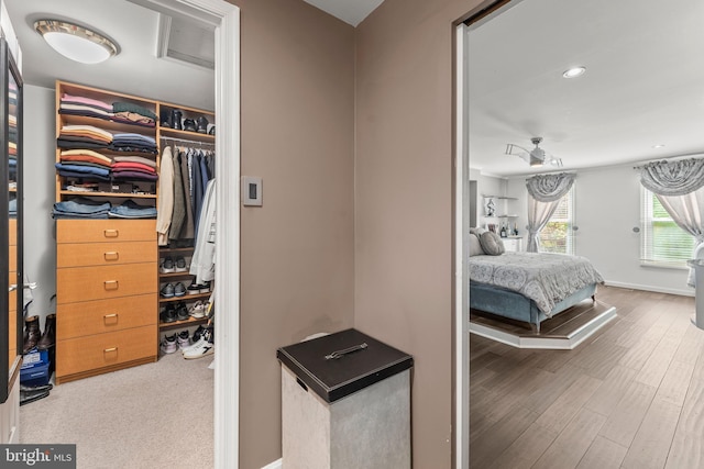bedroom with recessed lighting, wood finished floors, and baseboards