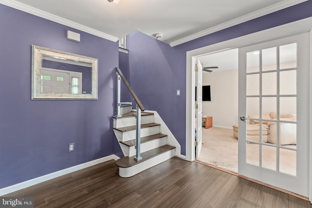staircase with baseboards, ornamental molding, ceiling fan, and wood finished floors