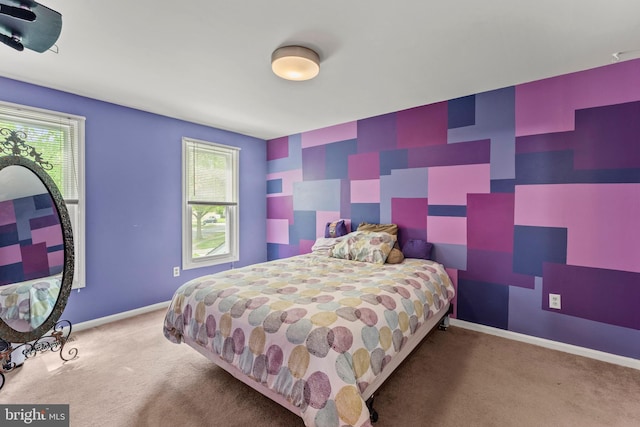 carpeted bedroom with baseboards and multiple windows