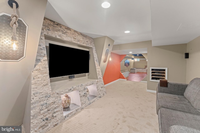 carpeted living area featuring baseboards and recessed lighting
