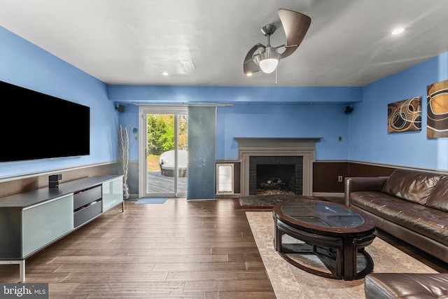 living room with a fireplace, wood finished floors, ceiling fan, and recessed lighting