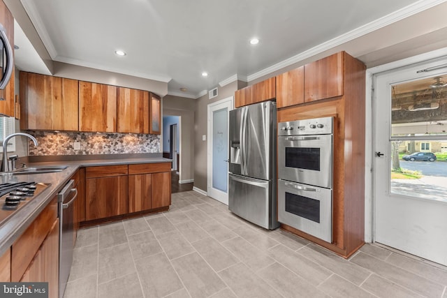 kitchen with tasteful backsplash, brown cabinets, stainless steel appliances, and a sink