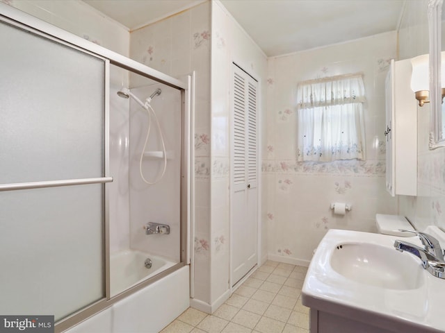 full bath with tile patterned floors, vanity, and shower / bath combination with glass door