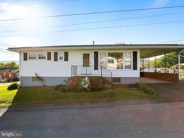 view of front of property with an attached carport and driveway