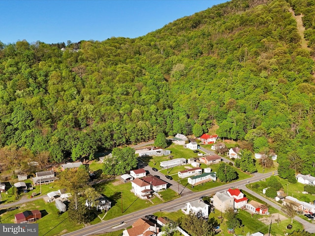 birds eye view of property featuring a residential view and a view of trees