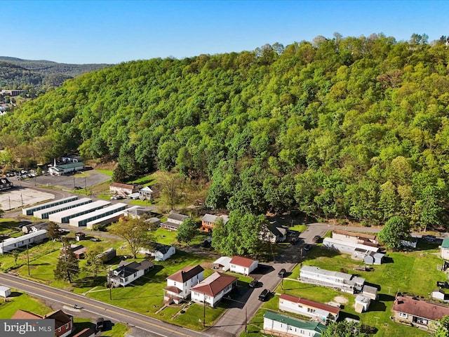 drone / aerial view featuring a view of trees and a residential view