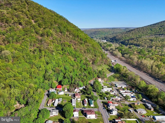 drone / aerial view featuring a forest view and a residential view