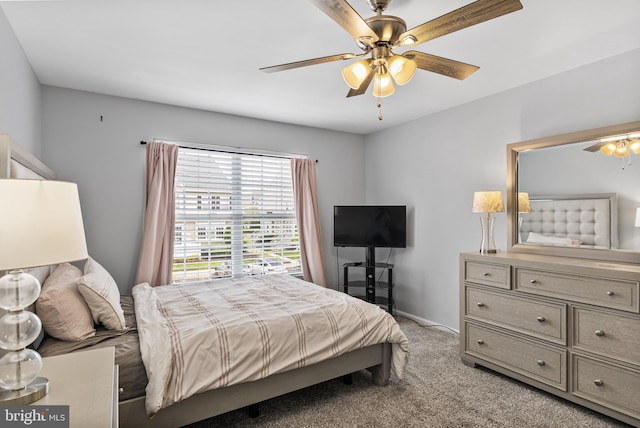 bedroom with light colored carpet, baseboards, and ceiling fan