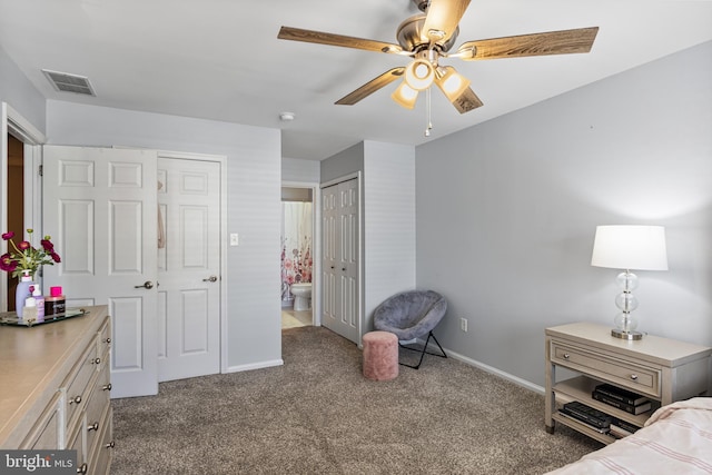 bedroom with dark colored carpet, a ceiling fan, baseboards, ensuite bathroom, and visible vents