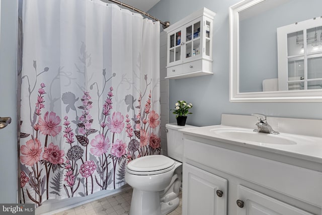 full bathroom with vanity, curtained shower, and toilet