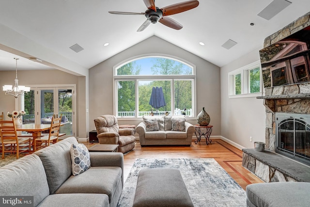 10935 Ravenwood Dr, Manassas, VA 20111 - living area featuring light wood-style floors, a fireplace, ceiling fan with notable chandelier, baseboards, and lofted ceiling