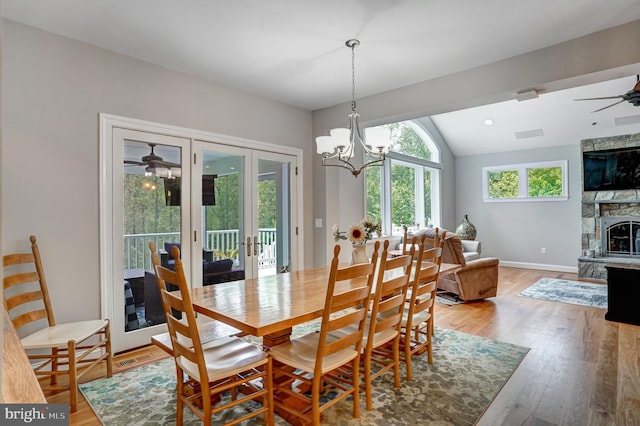 10935 Ravenwood Dr, Manassas, VA 20111 - dining area featuring french doors, vaulted ceiling, baseboards, ceiling fan with notable chandelier, and light wood finished floors