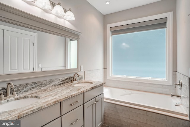 10935 Ravenwood Dr, Manassas, VA 20111 - bathroom featuring double vanity, a sink, and a bath