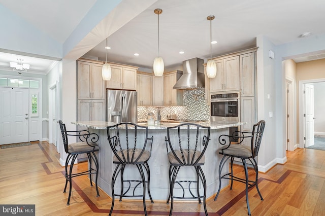 10935 Ravenwood Dr, Manassas, VA 20111 - kitchen featuring wall chimney range hood, stainless steel appliances, decorative backsplash, and a kitchen bar