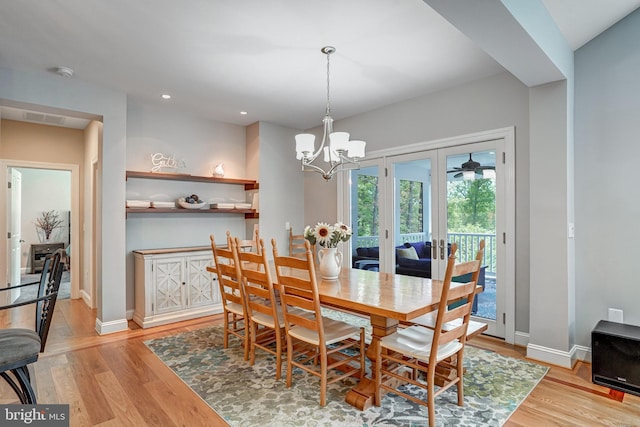 10935 Ravenwood Dr, Manassas, VA 20111 - dining space featuring light wood-type flooring, baseboards, a chandelier, and french doors