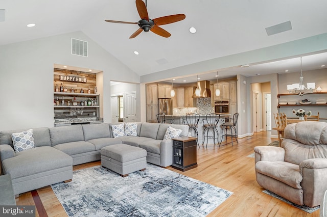 10935 Ravenwood Dr, Manassas, VA 20111 - living room featuring visible vents, high vaulted ceiling, recessed lighting, light wood-type flooring, and ceiling fan with notable chandelier