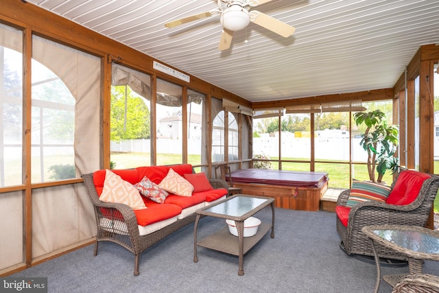 sunroom / solarium featuring outdoor lounge area, a ceiling fan, and a jacuzzi