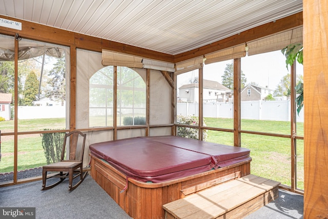 sunroom / solarium featuring a hot tub