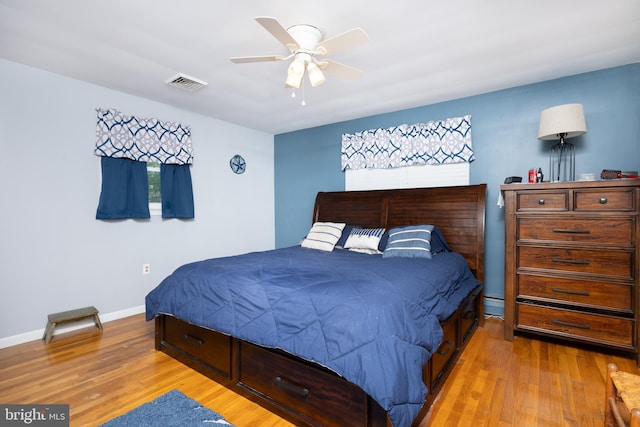 bedroom featuring baseboards, visible vents, ceiling fan, and light wood-style floors