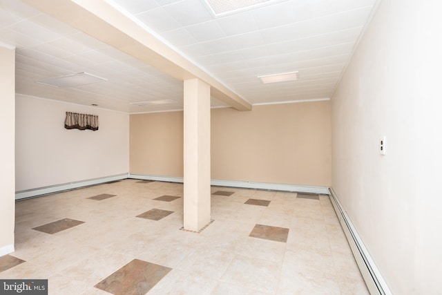finished basement with visible vents and a baseboard radiator