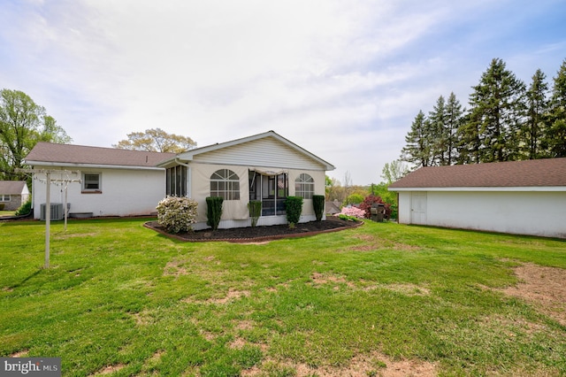 back of property featuring a yard, central AC unit, and a sunroom